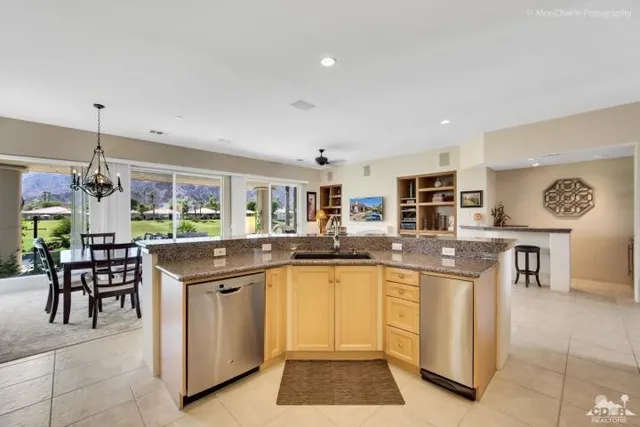 a kitchen with stainless steel appliances granite countertop a stove and white cabinets