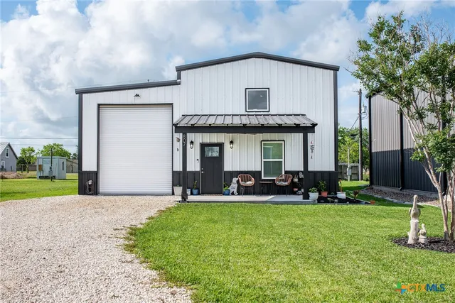 a front view of house with yard and outdoor seating