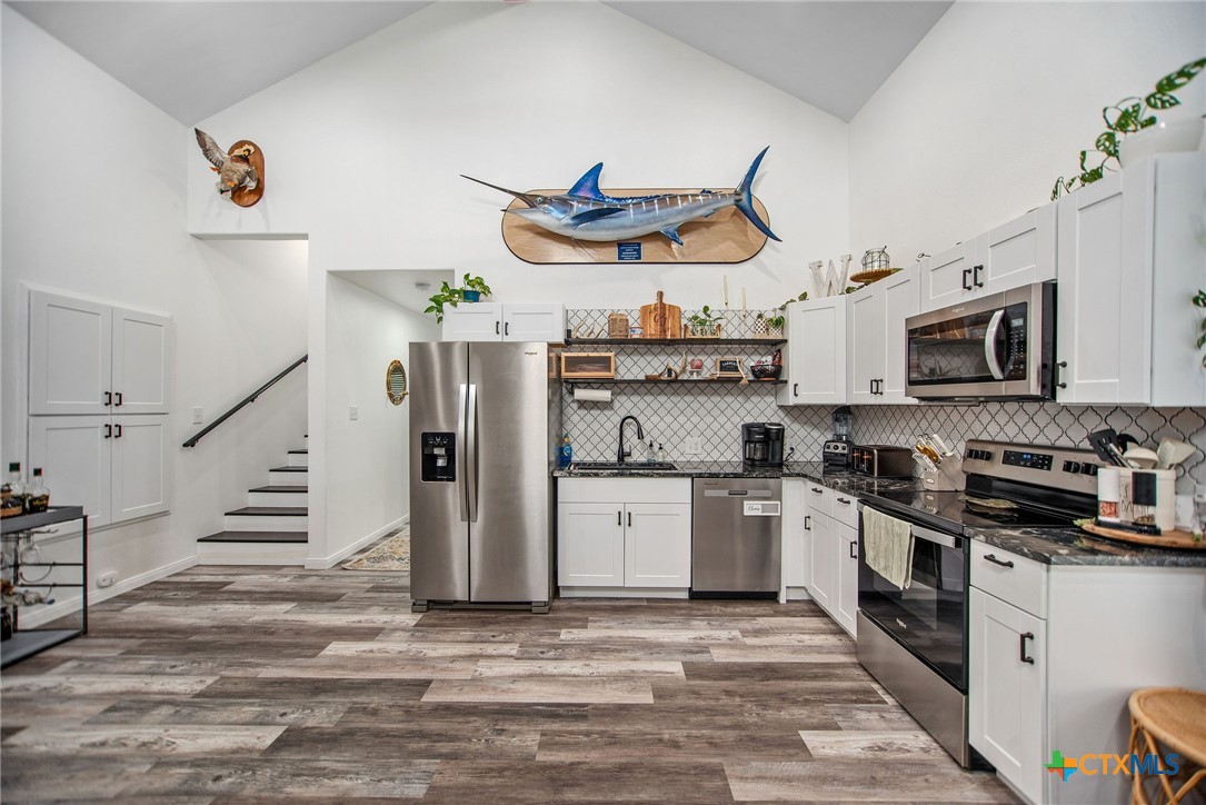 807 Dallas Avenue Seadrift, TX 77983 - Photo 12 of 35 a kitchen with stainless steel appliances granite countertop a refrigerator and a stove top oven
