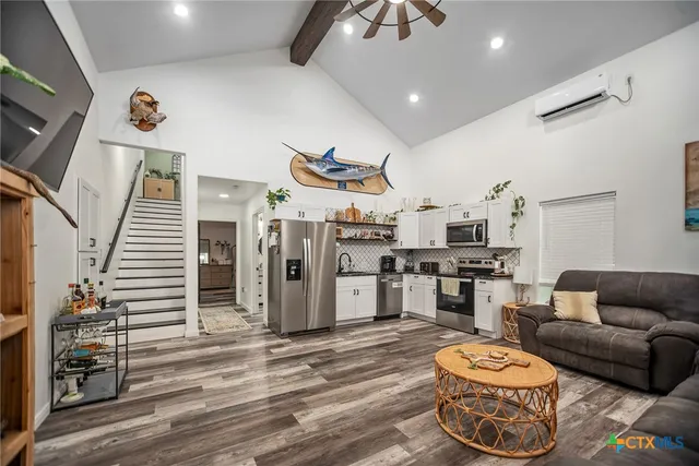 a living room with furniture and wooden floor