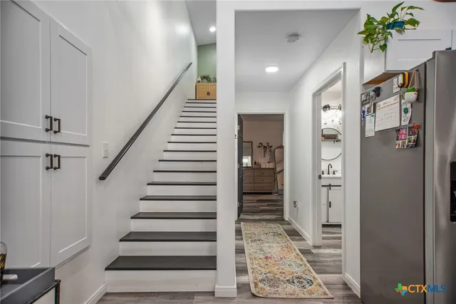 a view of entryway with stairs and wooden floor
