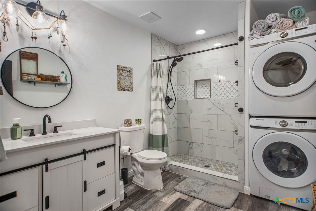 807 Dallas Avenue Seadrift, TX 77983 - Photo 16 of 35 a bathroom with a sink mirror toilet and shower