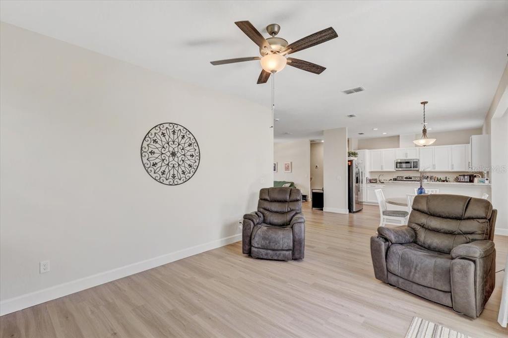 7314 Madrid Road Weeki Wachee, FL 34613 - Photo 12 of 54 a living room with furniture and kitchen view