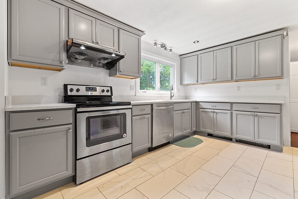 8 Winifred Road Framingham, MA 01701 - Photo 12 of 40 a kitchen with a stove sink and cabinets