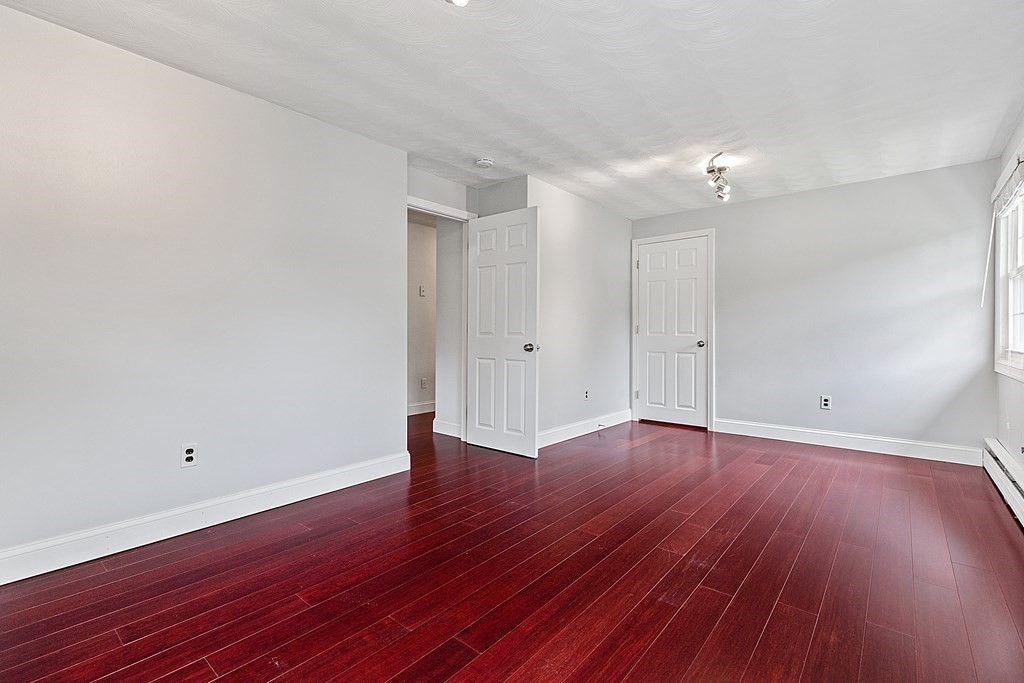 8 Winifred Road Framingham, MA 01701 - Photo 18 of 40 an empty room with wooden floor and windows