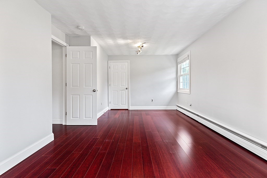 8 Winifred Road Framingham, MA 01701 - Photo 19 of 40 an empty room with wooden floor and windows