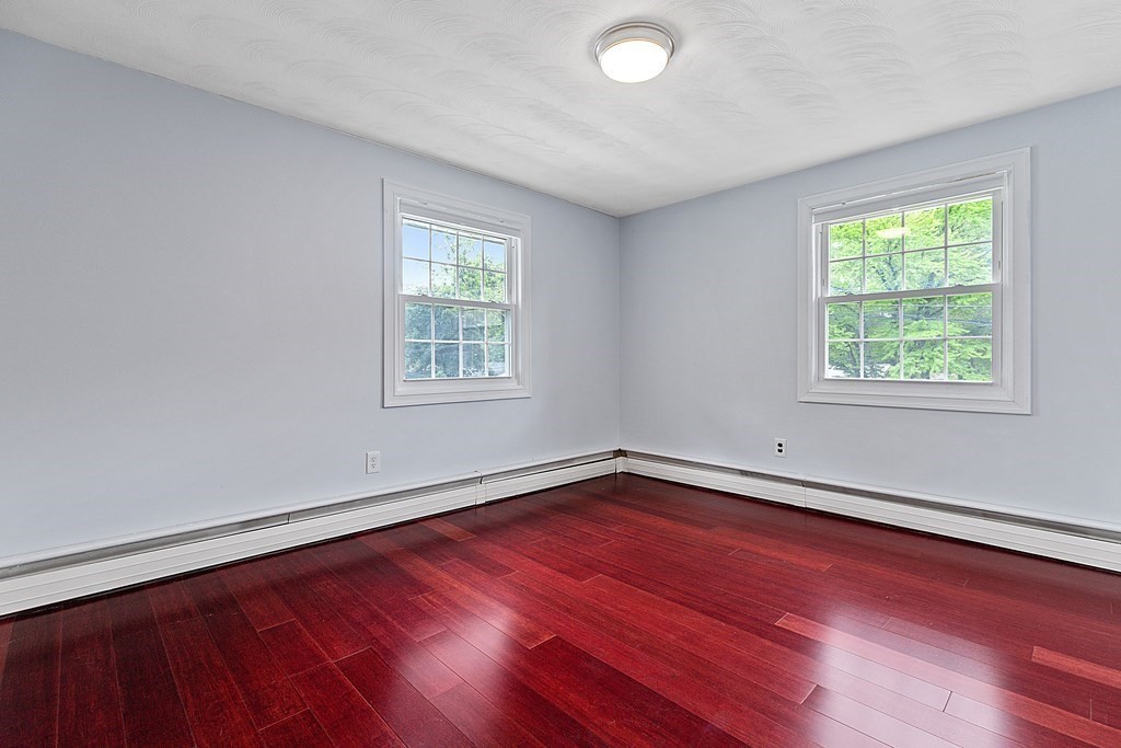 8 Winifred Road Framingham, MA 01701 - Photo 22 of 40 an empty room with wooden floor and windows