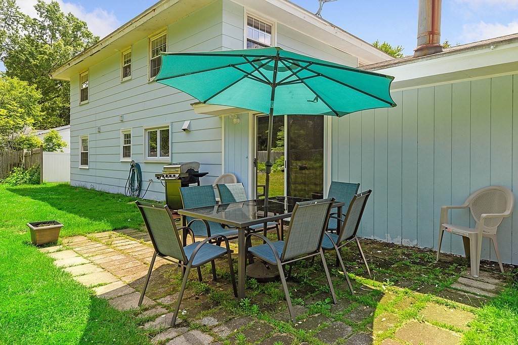 8 Winifred Road Framingham, MA 01701 - Photo 31 of 40 a view of a backyard with table and chairs under an umbrella