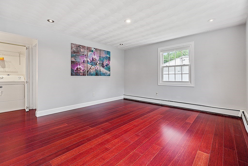 8 Winifred Road Framingham, MA 01701 - Photo 7 of 40 a view of an empty room with wooden floor and a window