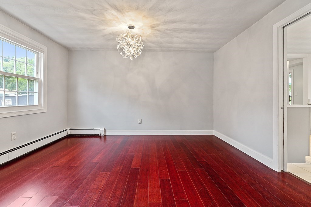 8 Winifred Road Framingham, MA 01701 - Photo 8 of 40 a view of an empty room with wooden floor and a window