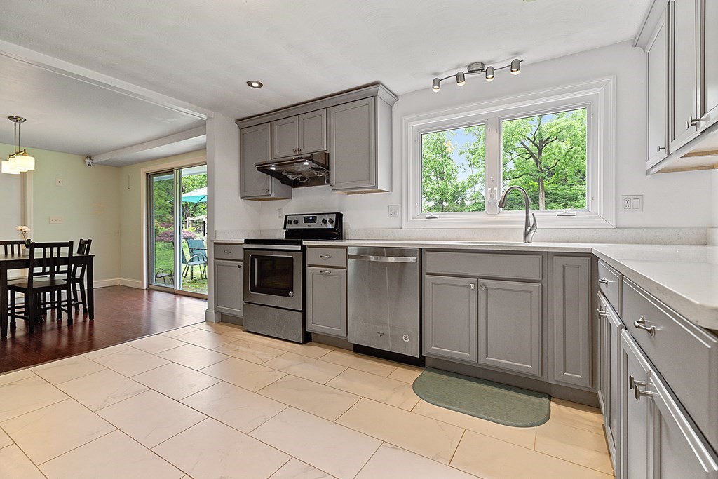 8 Winifred Road Framingham, MA 01701 - Photo 10 of 40 a kitchen with stainless steel appliances granite countertop a stove a sink and a microwave