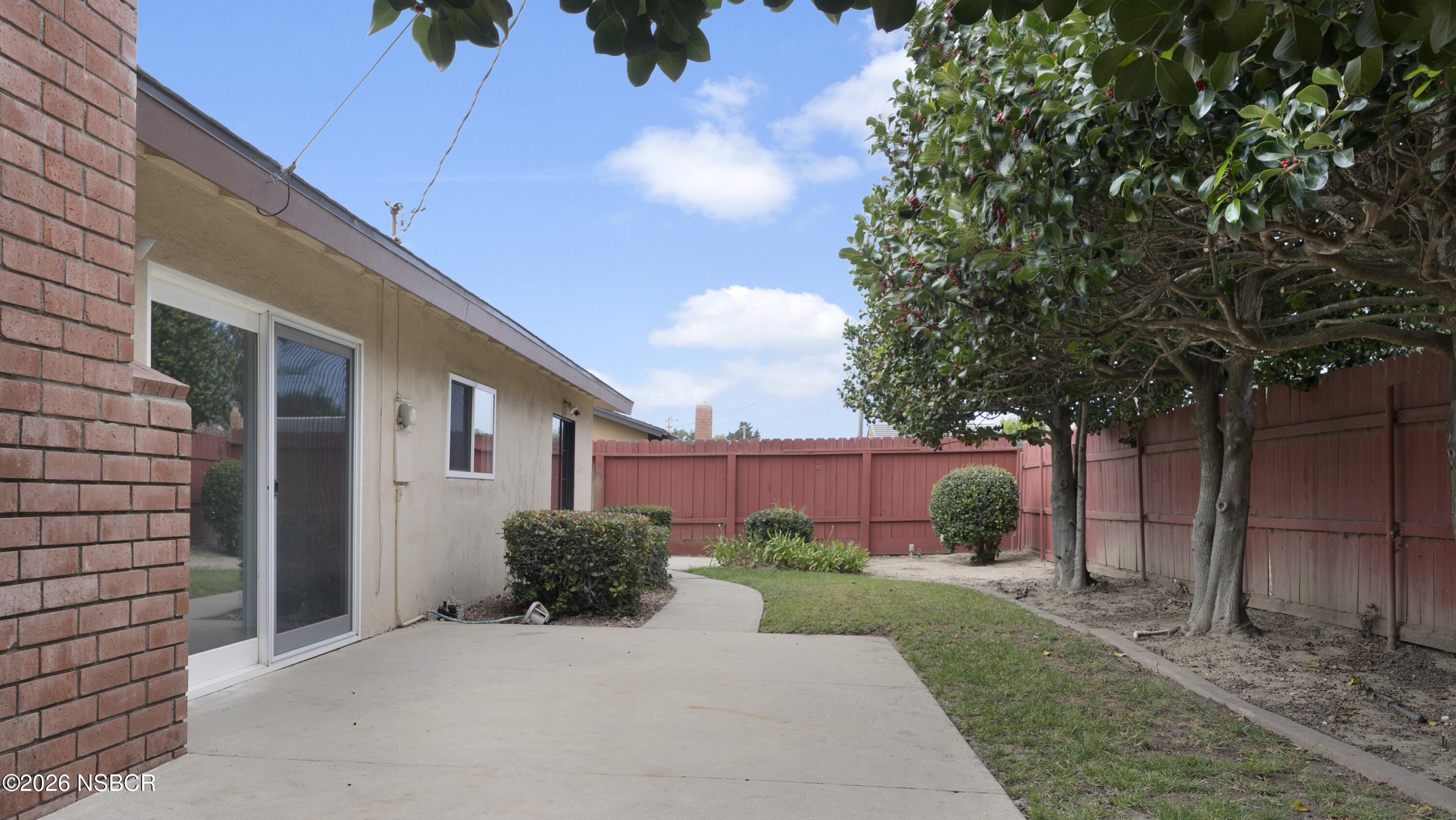1312 North First Place Lompoc, CA 93436 - Photo 35 of 38 a front view of a house with a yard and a garage