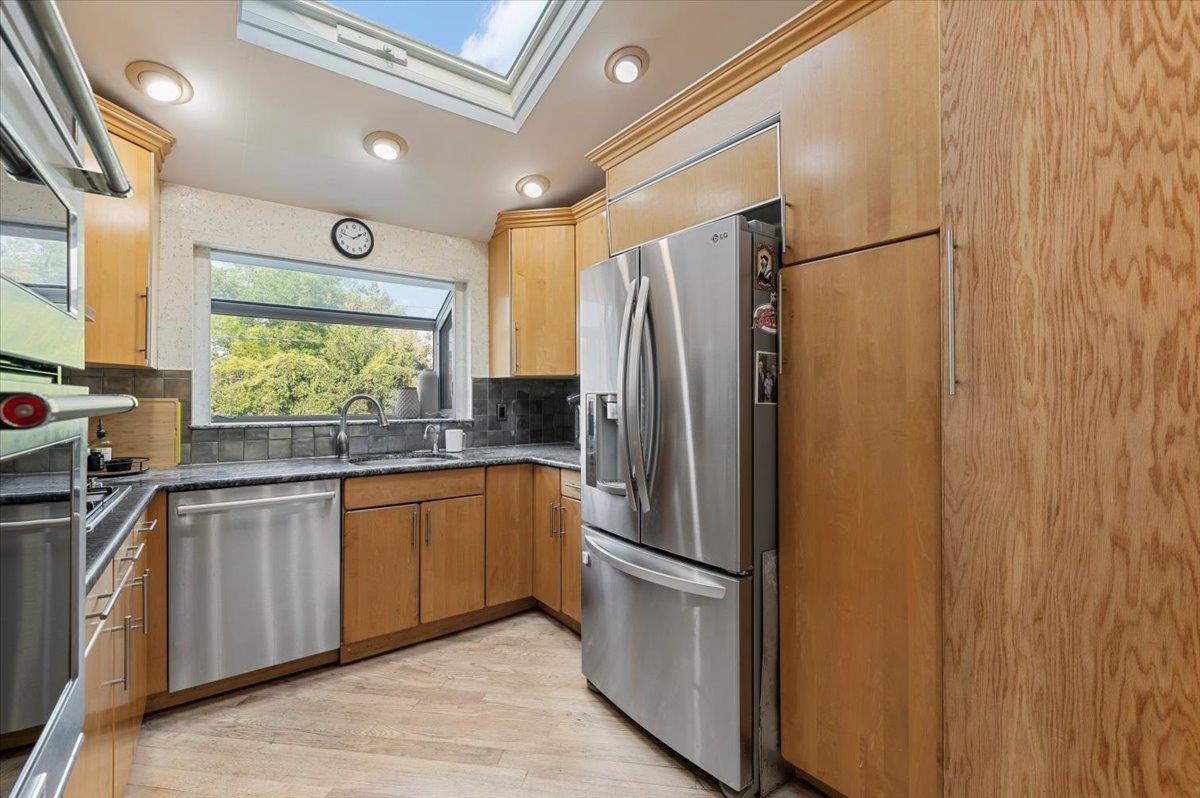 722 Eagle Drive Valley Stream, NY 11581 - Photo 14 of 35 a kitchen with stainless steel appliances granite countertop a refrigerator and a sink