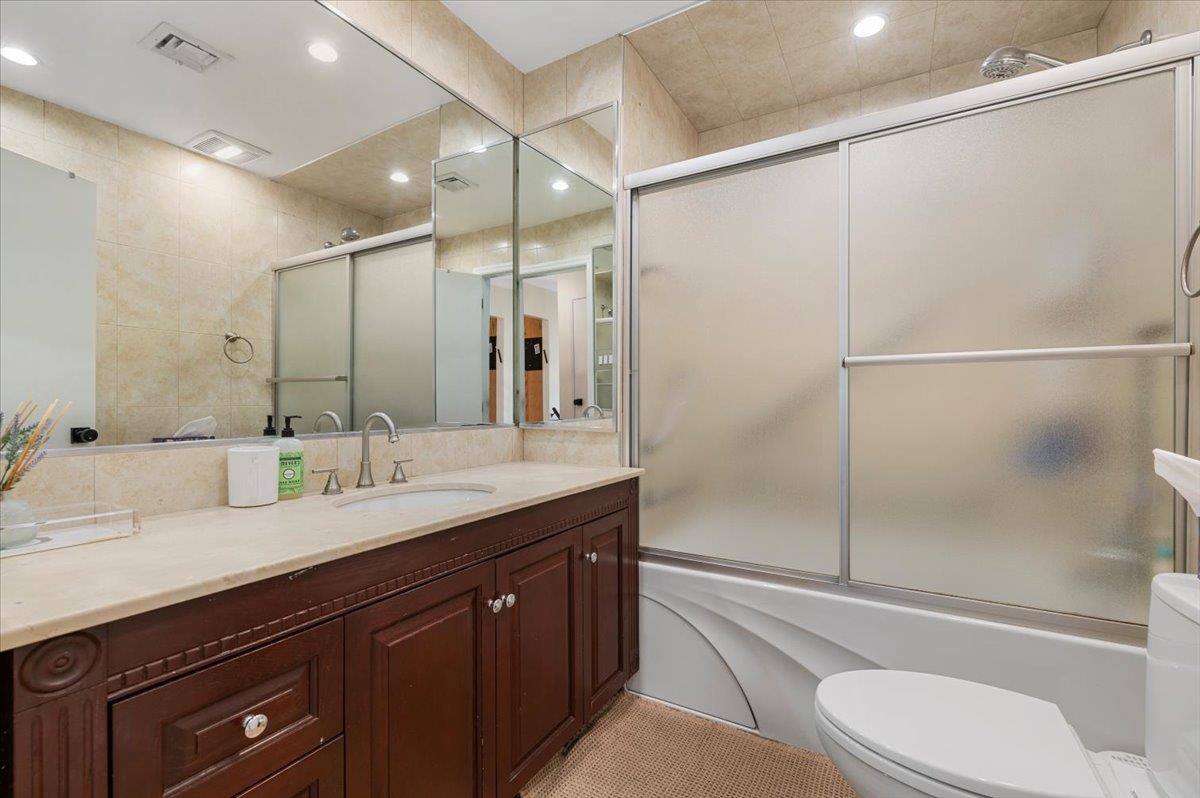 722 Eagle Drive Valley Stream, NY 11581 - Photo 15 of 35 a bathroom with a granite countertop sink toilet and shower