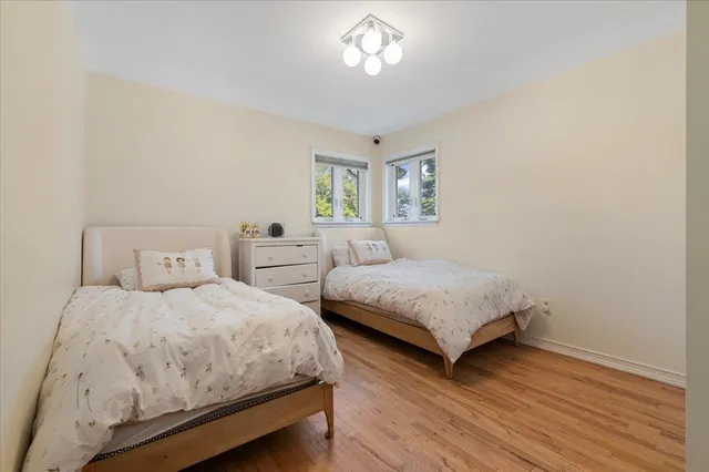 a bedroom with two beds and a window