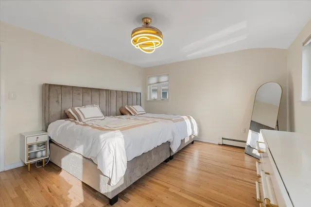 a bedroom with bed and a window