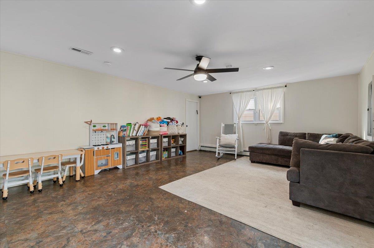 722 Eagle Drive Valley Stream, NY 11581 - Photo 23 of 35 a living room with furniture and a flat screen tv