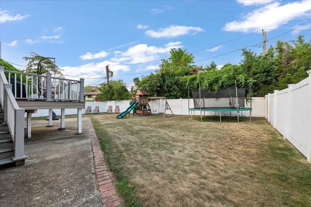 a view of a swimming pool with a bench and lawn chairs