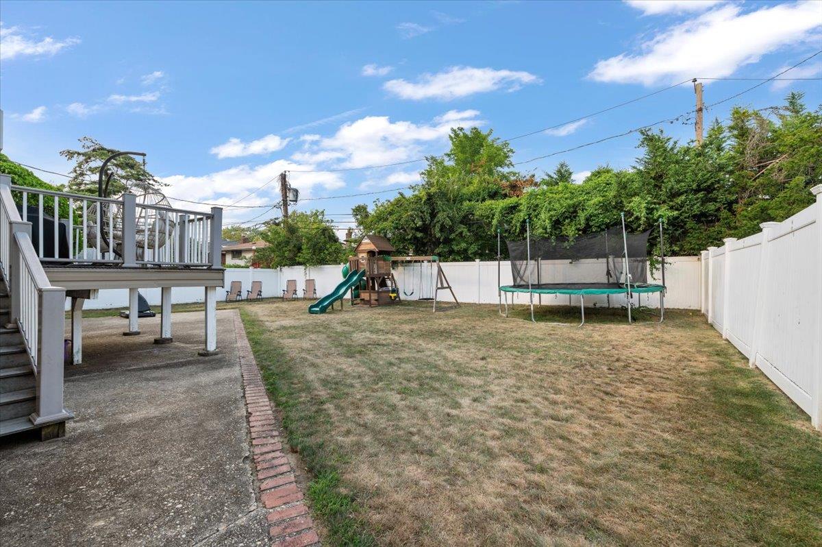 722 Eagle Drive Valley Stream, NY 11581 - Photo 32 of 35 a view of a swimming pool with a bench and lawn chairs