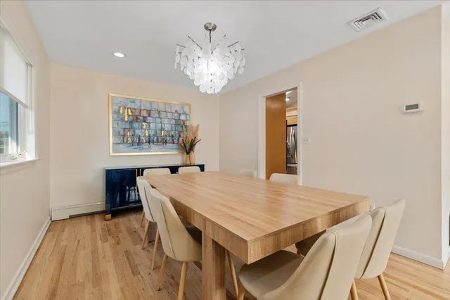 a view of a dining room with furniture and chandelier