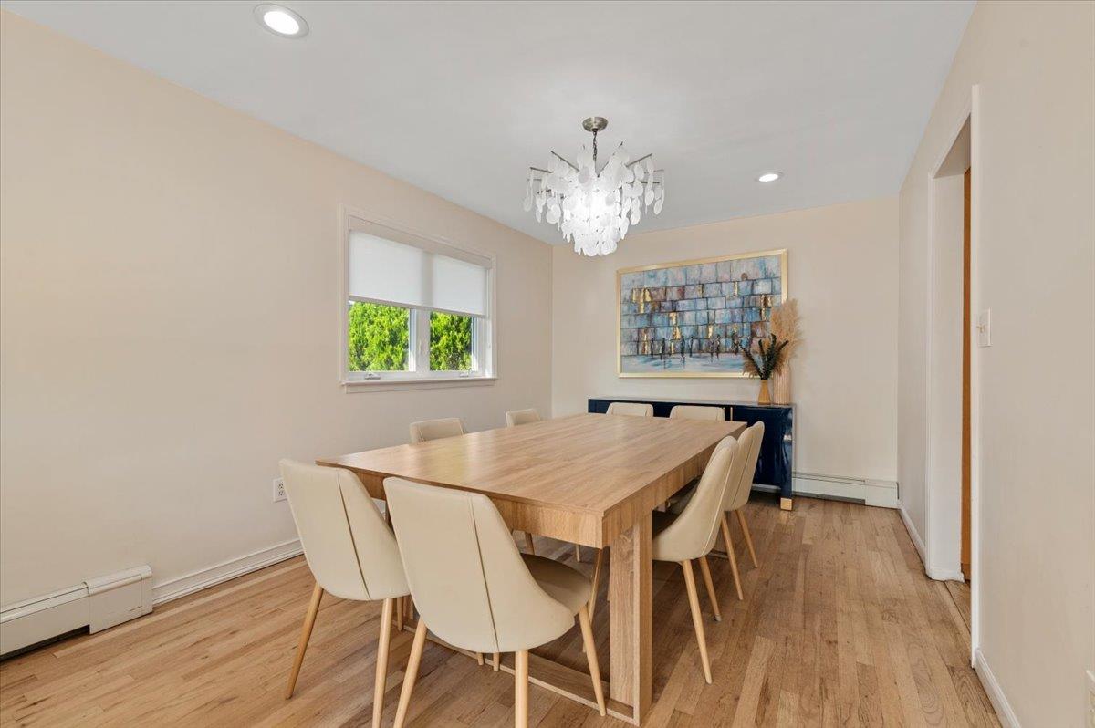 722 Eagle Drive Valley Stream, NY 11581 - Photo 8 of 35 a view of a dining room with furniture a chandelier and wooden floor