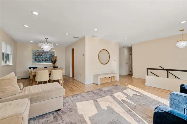 a living room with furniture and a mirror