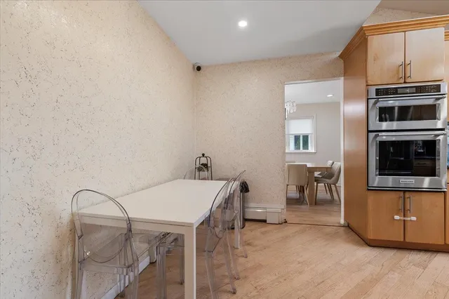a view of a kitchen with furniture and electronic appliances