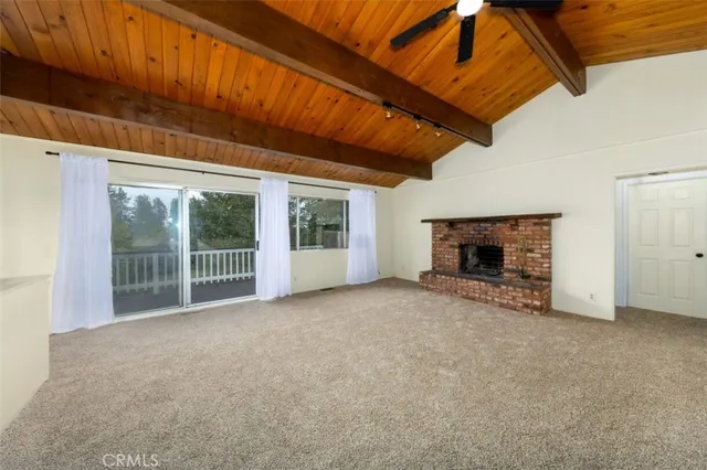 a view of empty room with a fireplace
