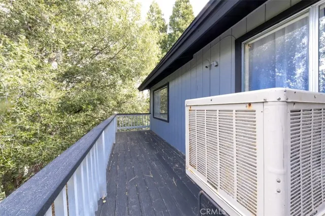 a view of balcony with wooden floor and fence