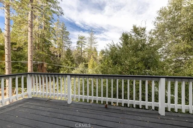 a balcony with wooden floor and fence
