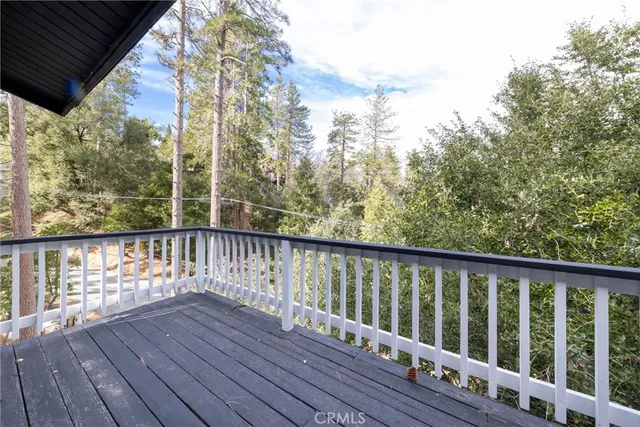 a balcony with wooden floor and outdoor space