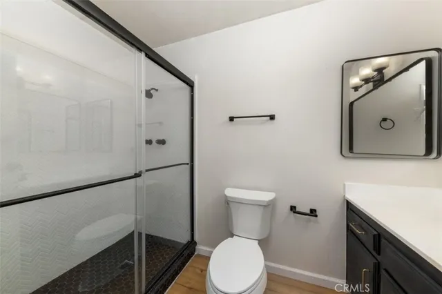 a white toilet sitting next to a bathroom sink