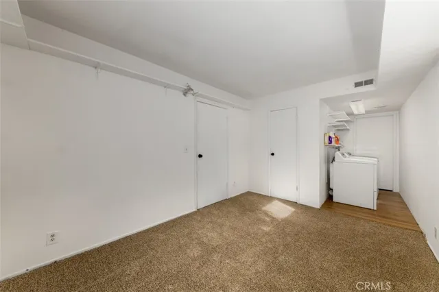 a view of a room with wooden floor