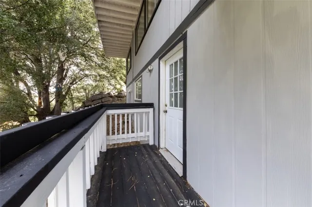 a view of balcony with wooden floor and fence