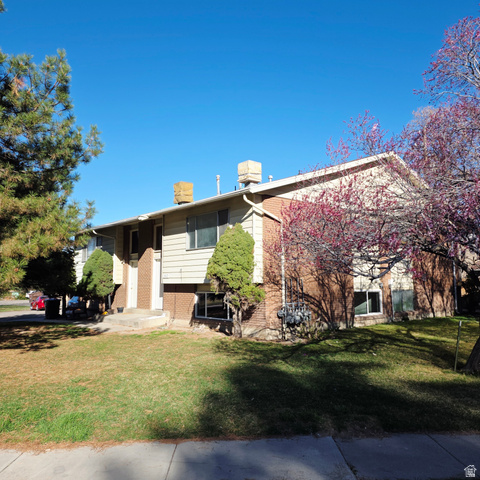 8408 Foxbridge Circle Midvale, UT 84047 - Photo 1 of 1 View of front facade with brick siding and a front lawn