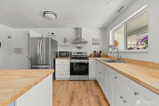 a living room with furniture a fireplace and a potted plant
