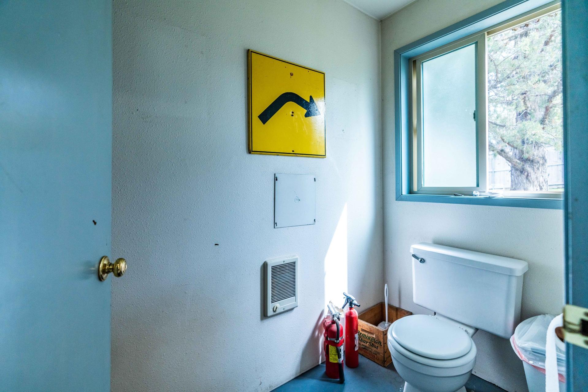 61919 Dobbin Road Bend, OR 97702 - Photo 30 of 57 a bathroom with a toilet and a shower curtain