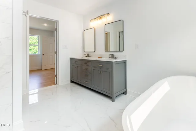 a spacious bathroom with a double vanity sink and a mirror