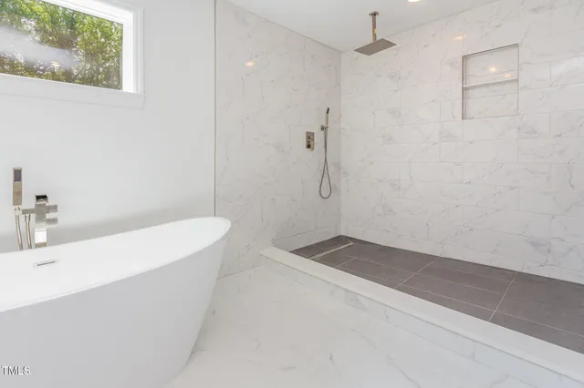 a bathroom with a bathtub and shower