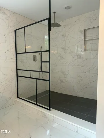 a bathroom with a glass shower door
