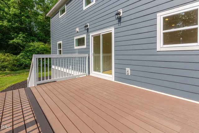 a view of backyard with deck and garden