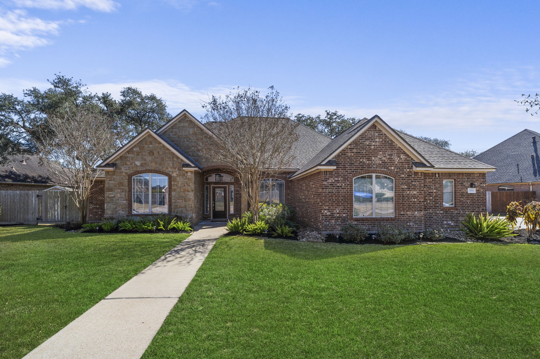 Lakefront living takes center stage at 1012 Enchanted Oaks, a custom-built home situated on a large waterfront lot with unobstructed views of the lake.