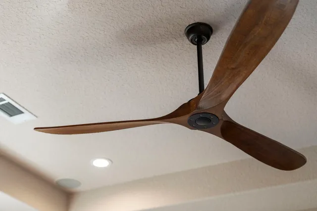 a bedroom with a bed a desk and chair with a mirror