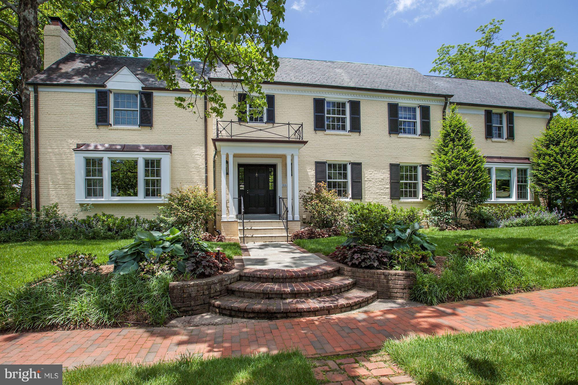 a front view of a house with a yard and porch