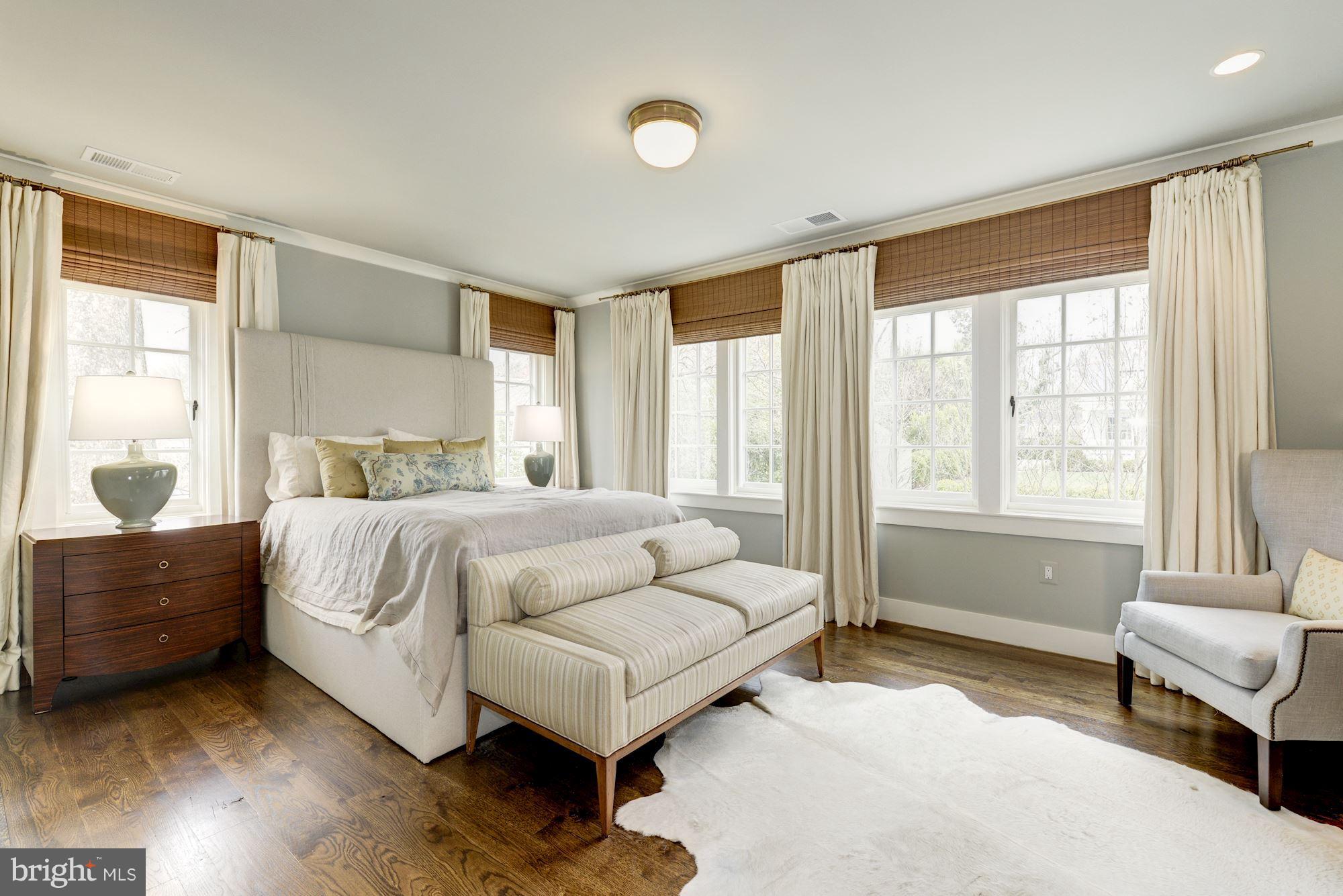 6134 Nevada Avenue Chevy Chase, MD 20815 - Photo 15 of 30 a bedroom with a bed and a couch next to a window