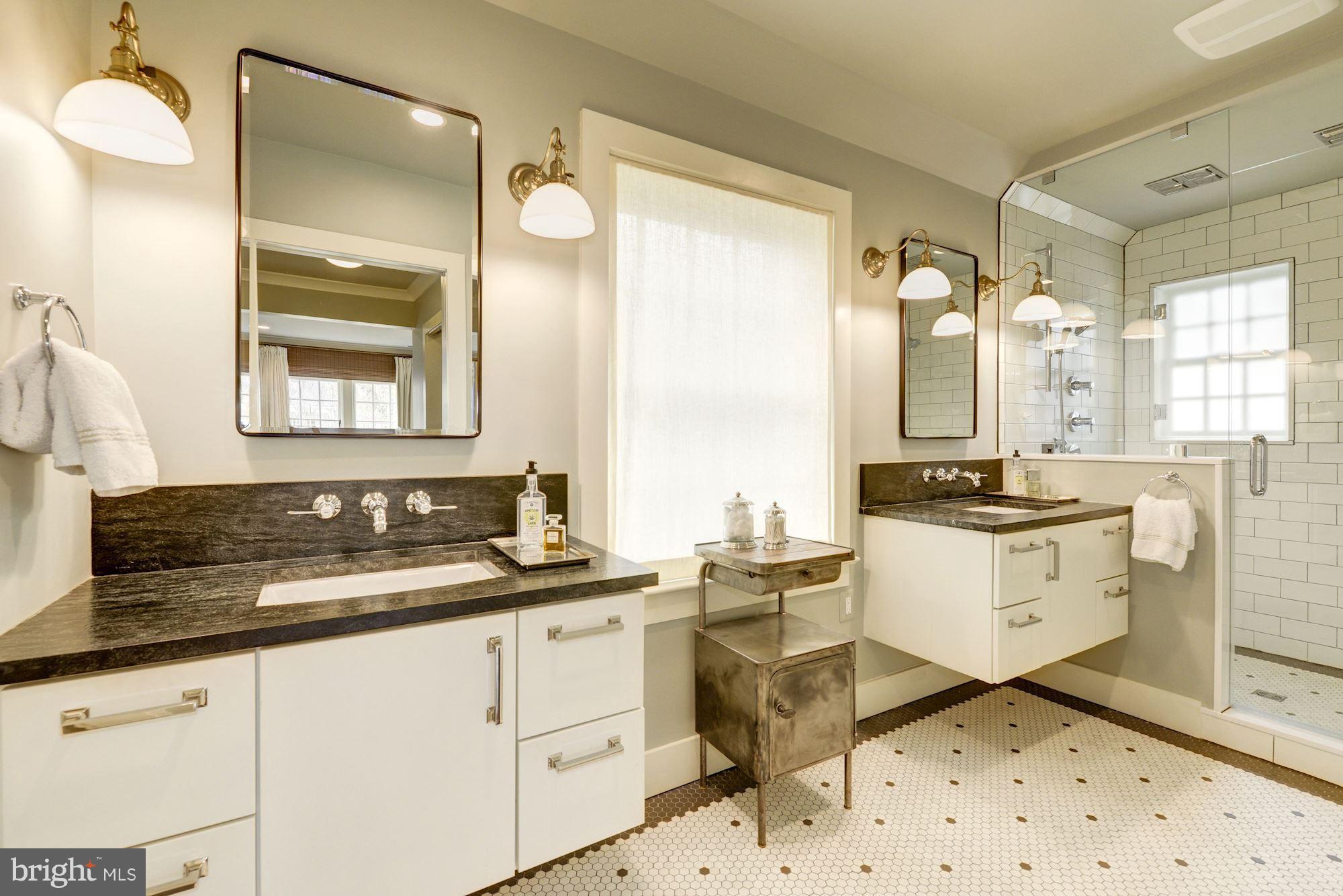 6134 Nevada Avenue Chevy Chase, MD 20815 - Photo 17 of 30 a bathroom with a sink mirror and a bathtub