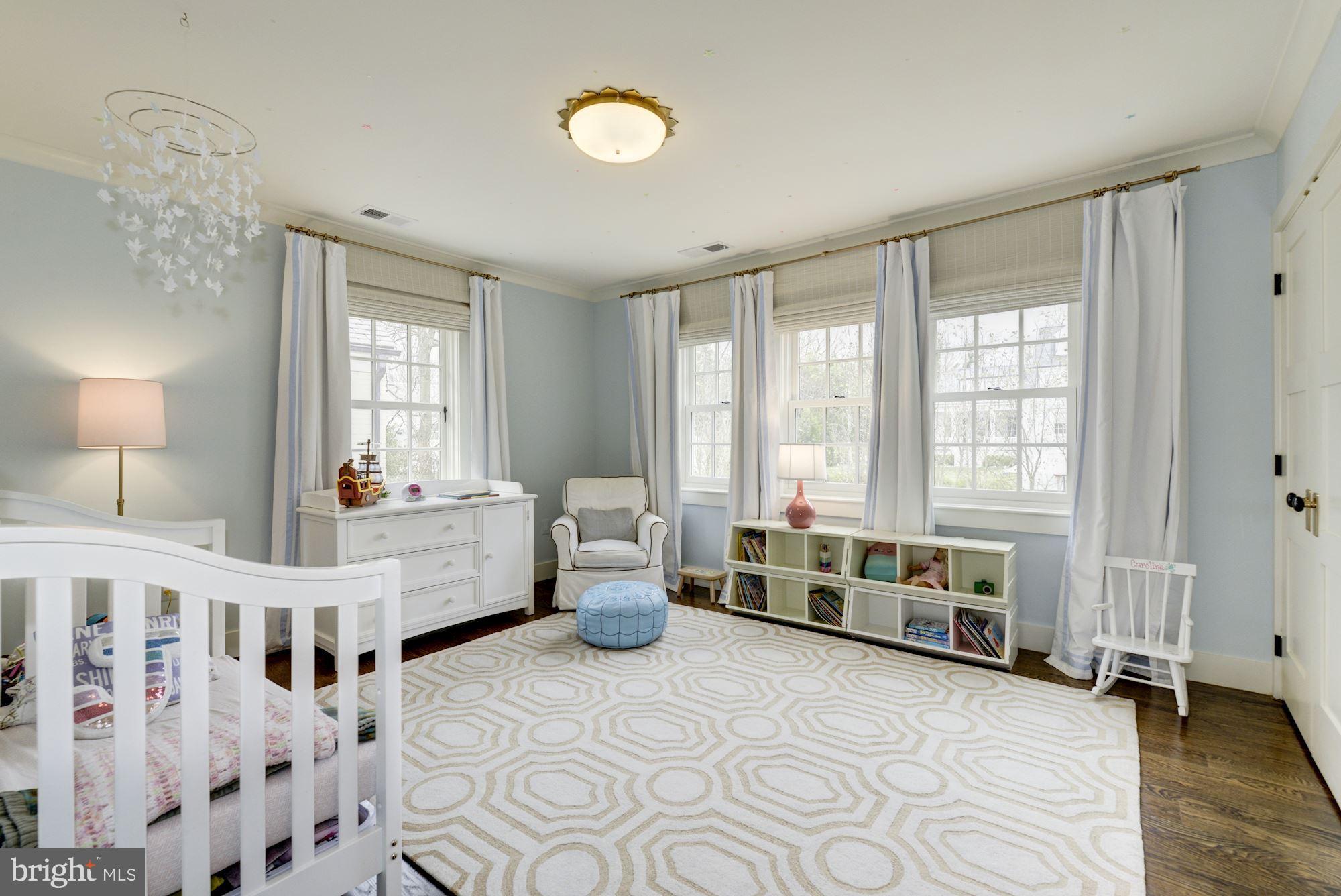 6134 Nevada Avenue Chevy Chase, MD 20815 - Photo 19 of 30 a large white bedroom with a large bed and a window