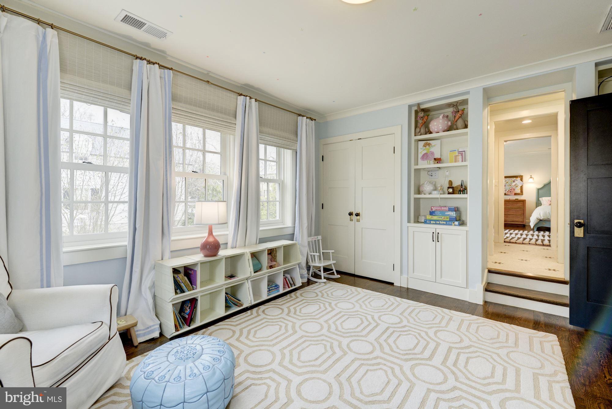 6134 Nevada Avenue Chevy Chase, MD 20815 - Photo 20 of 30 a spacious bedroom with a large bed and a couch