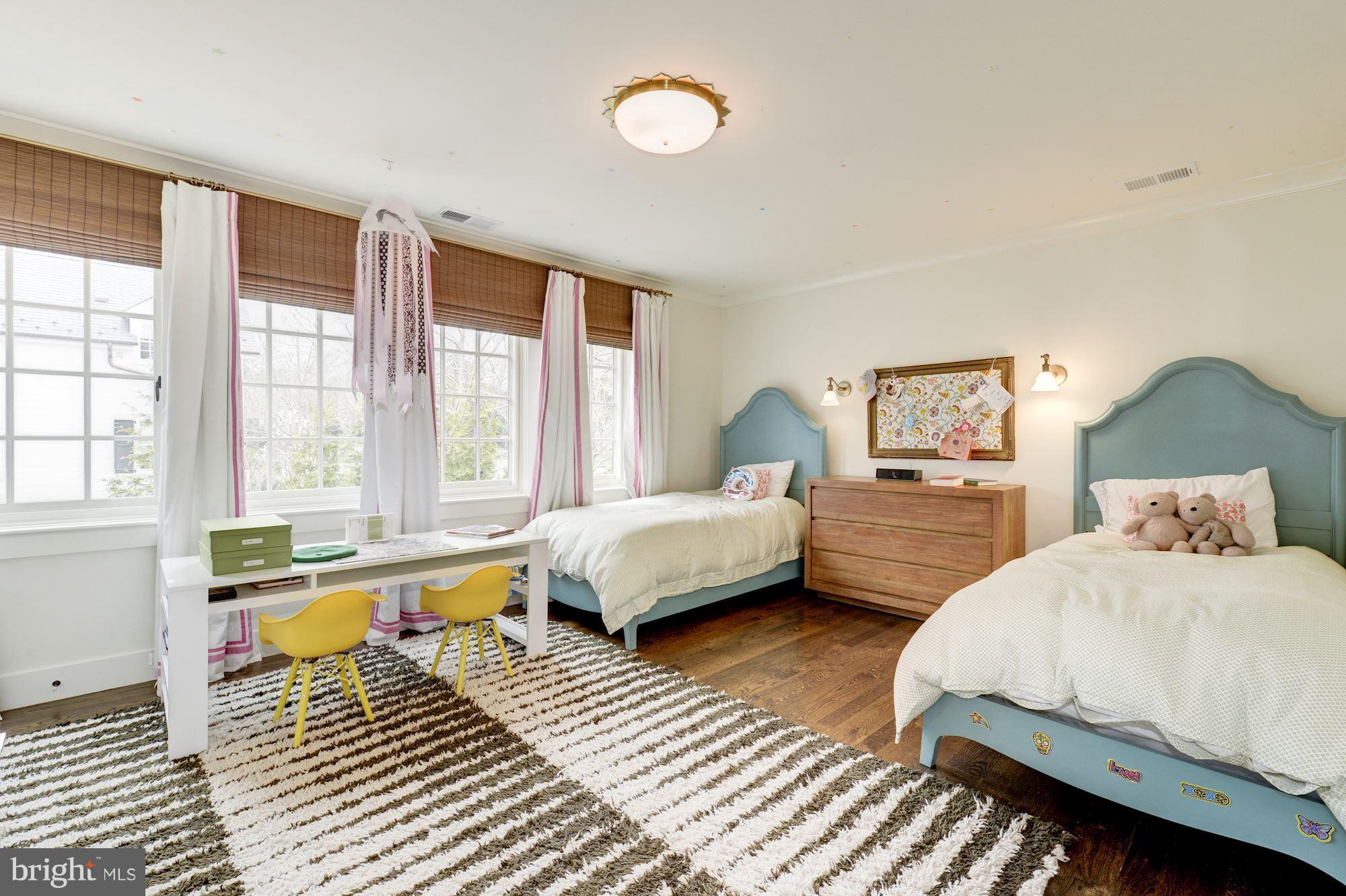 6134 Nevada Avenue Chevy Chase, MD 20815 - Photo 22 of 30 a spacious bedroom with a bed and glass windows