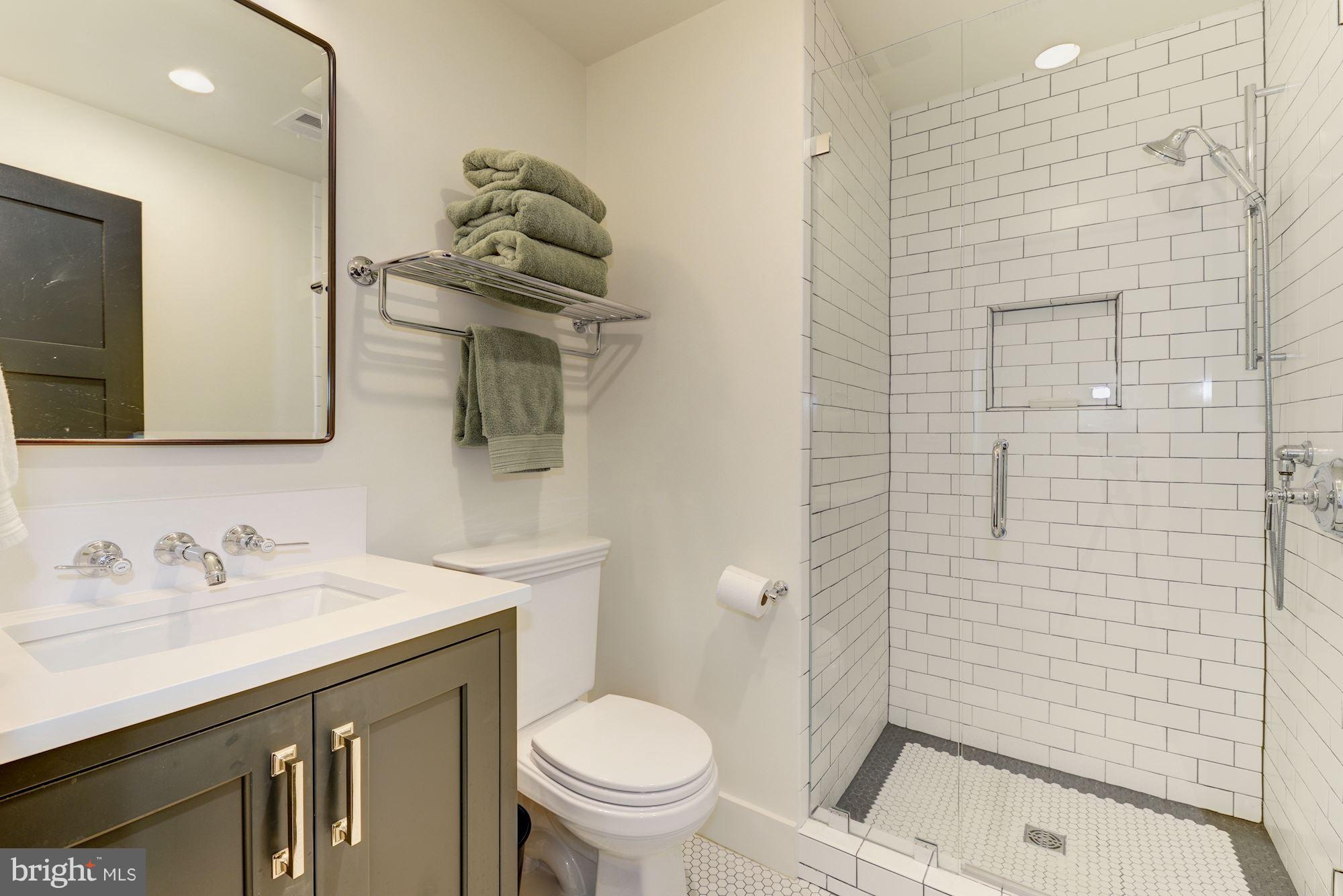 6134 Nevada Avenue Chevy Chase, MD 20815 - Photo 25 of 30 a bathroom with a sink a toilet and shower
